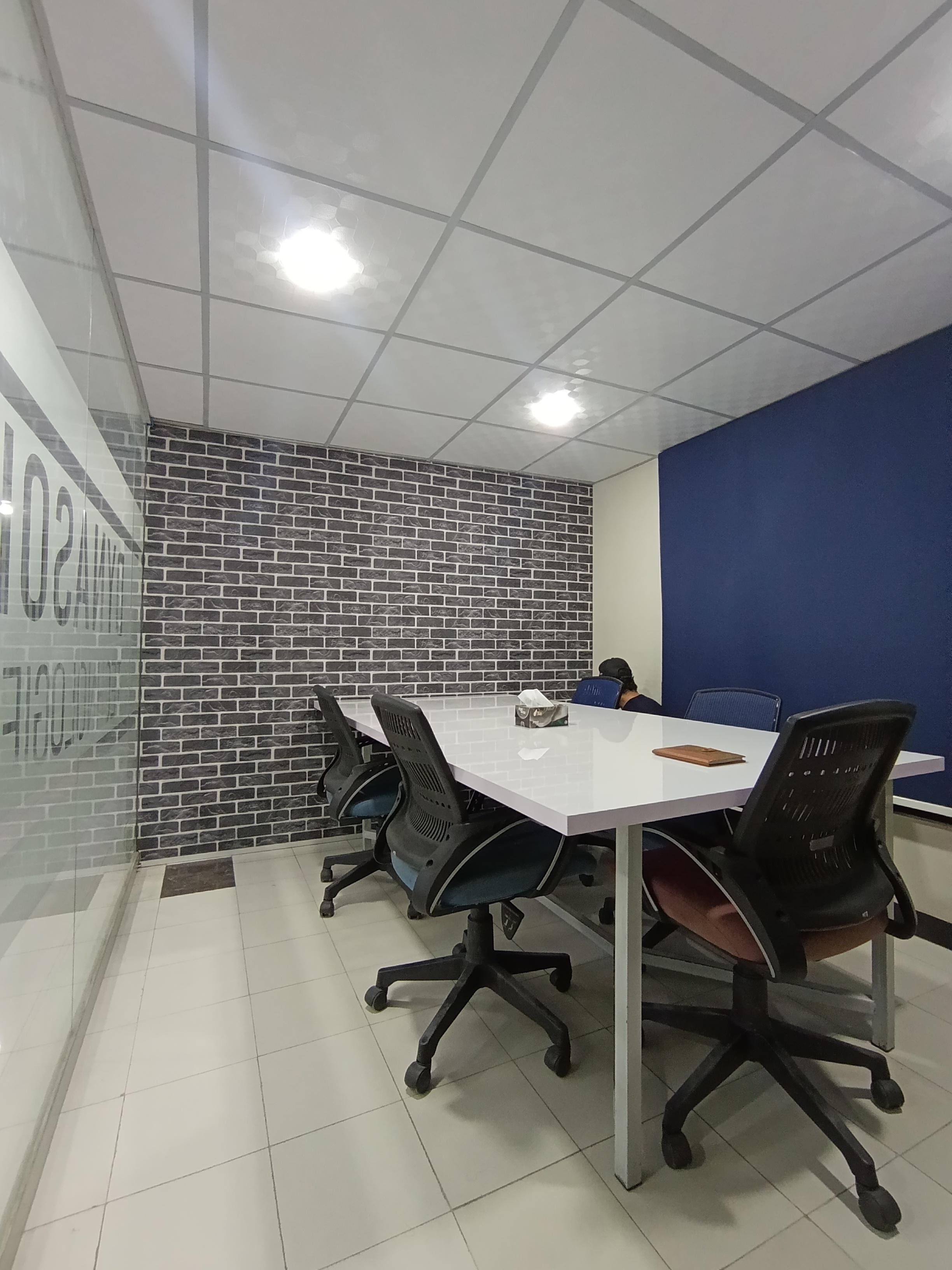 Open-plan workspace floor with shared desks
