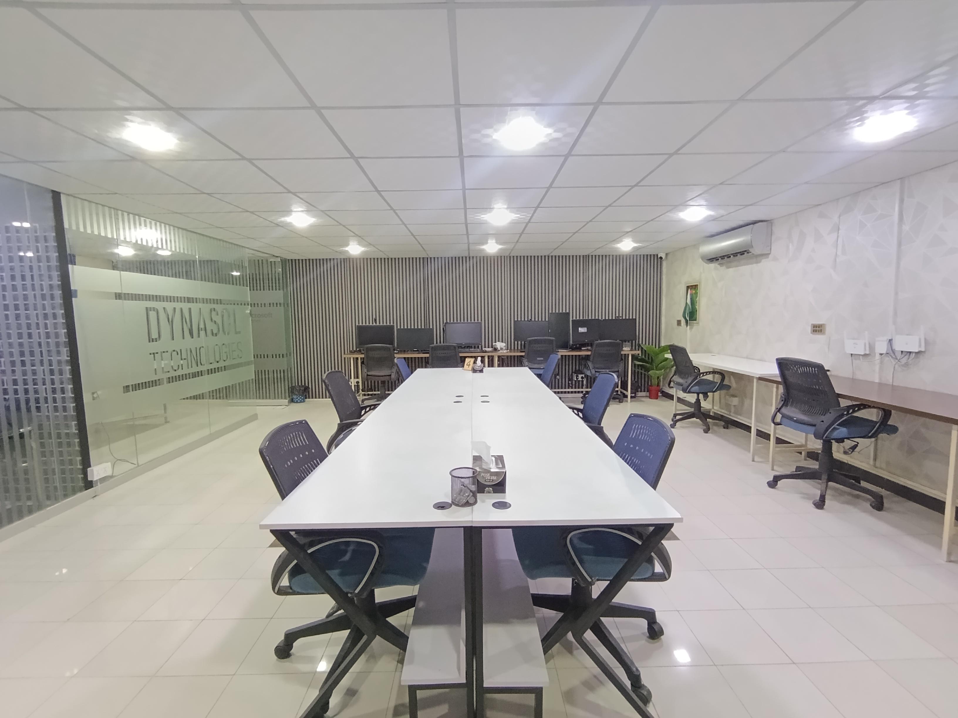 Members working at shared desks inside Dynasol Workspace